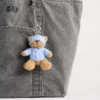 Ciondolo per borsa Brannan Bear a forma di sacco a pelo