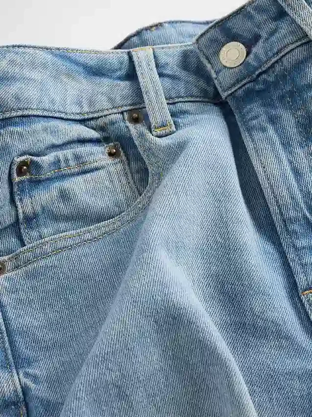 Jeans a gamba larga e caviglia, con vita alta e linea sinuosa