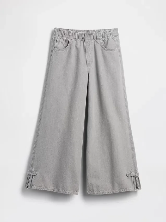 Jeans baggy a vita bassa con fiocco e orlo a spacco per bambini