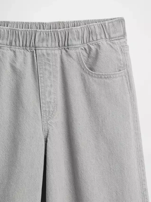 Jeans baggy a vita bassa con fiocco e orlo a spacco per bambini
