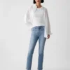 Jeans slim vintage a vita media con orlo a spacco