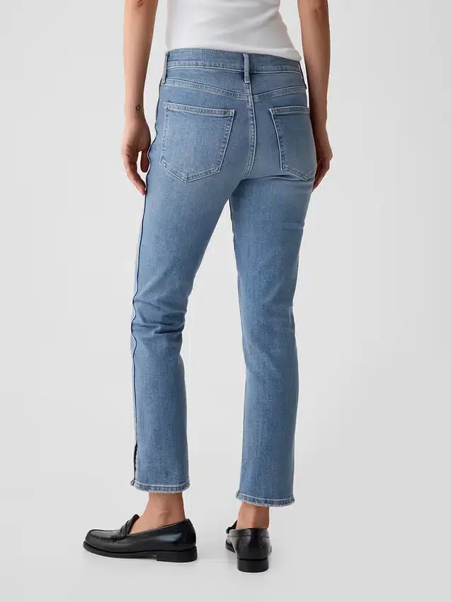 Jeans slim vintage a vita media con orlo a spacco