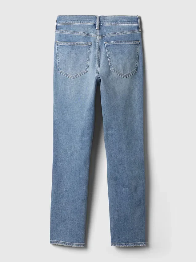 Jeans slim vintage a vita media con orlo a spacco