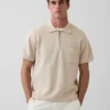 Maglia polo oversize con tasca e zip a un quarto