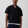 Maglia polo oversize con tasca e zip a un quarto