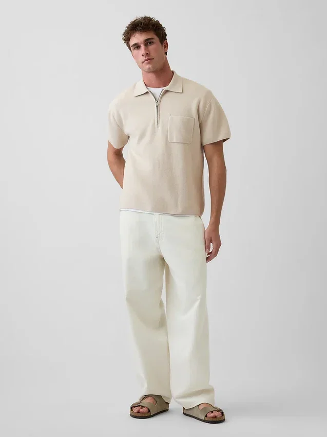 Maglia polo oversize con tasca e zip a un quarto