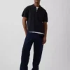 Maglia polo oversize con tasca e zip a un quarto