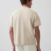 Maglia polo oversize con tasca e zip a un quarto