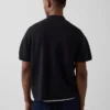 Maglia polo oversize con tasca e zip a un quarto