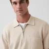Maglia polo oversize con tasca e zip a un quarto