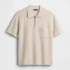 Maglia polo oversize con tasca e zip a un quarto
