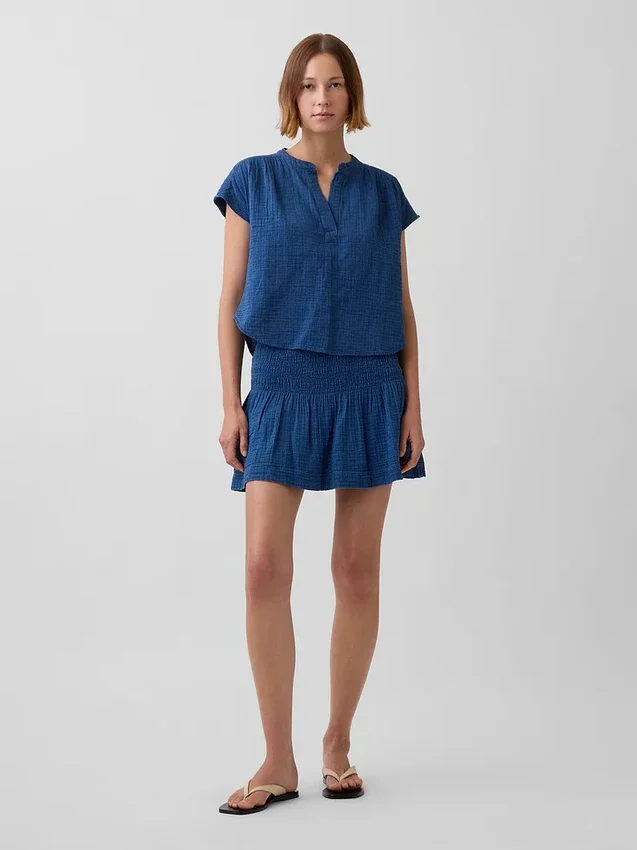 Mini gonna-pantaloncino in denim di garza di cotone con vita smockata