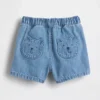 Pantaloncini in denim con tasche e orsetto Brannan per neonati