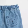 Pantaloncini in denim con tasche e orsetto Brannan per neonati
