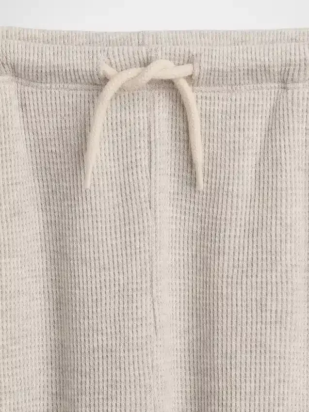 Pantaloni da bambino a gamba larga, comodi e dalla vestibilità rilassata, in maglia a nido d’ape