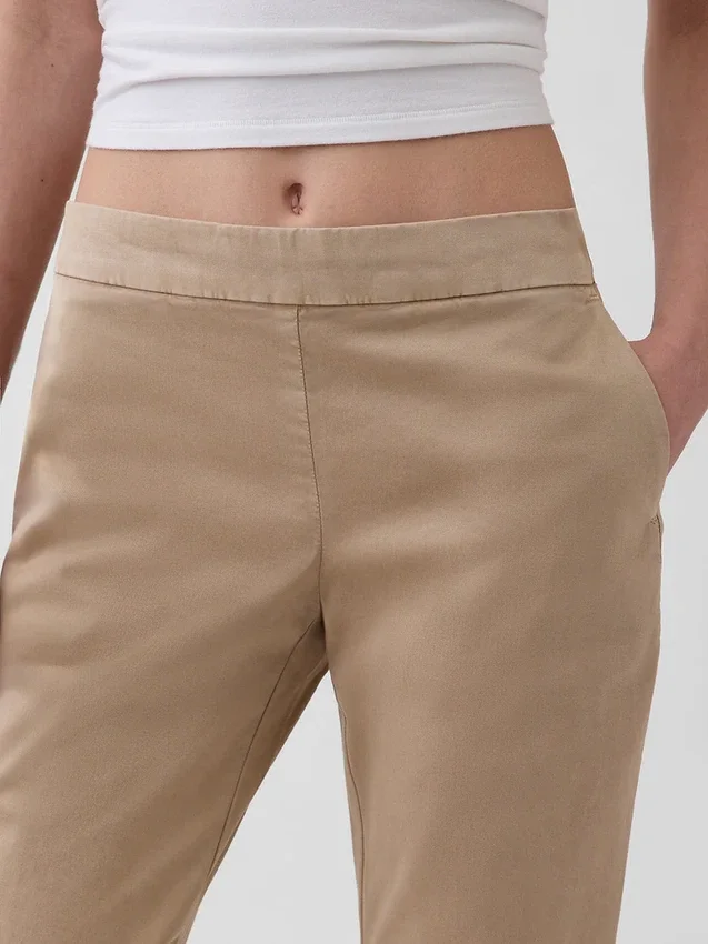Pantaloni kaki a zampa d’elefante aderenti a vita bassa