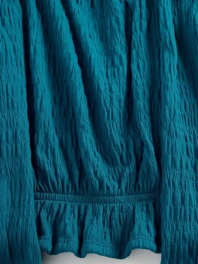 Top con peplo in maglia stropicciata per bambini