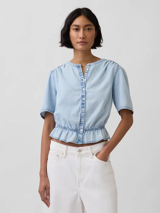 Top corto con peplo in denim