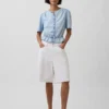 Top corto con peplo in denim