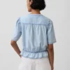 Top corto con peplo in denim