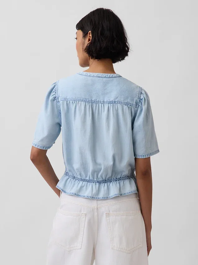 Top corto con peplo in denim