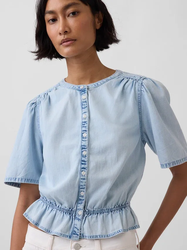 Top corto con peplo in denim