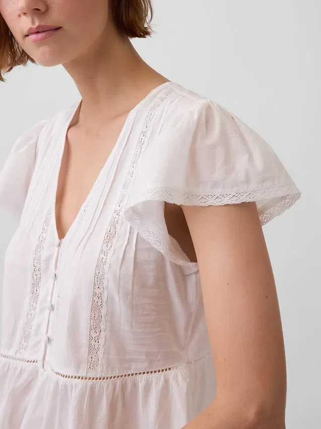 Top corto con peplo in voile di pizzo