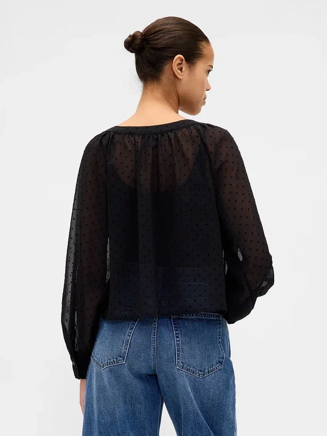 Top trasparente con abbottonatura frontale