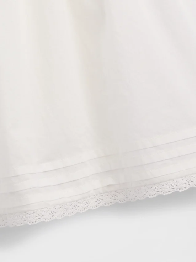 Tutina per bambini con bordi in pizzo